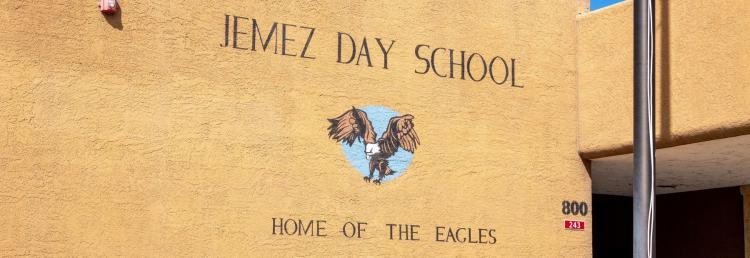 Jemez Day School Home of the Eagles written on outside of school building.