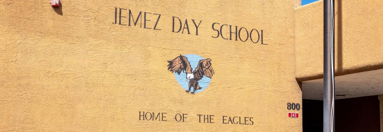 Jemez Day School Home of the Eagles written on outside of school building.