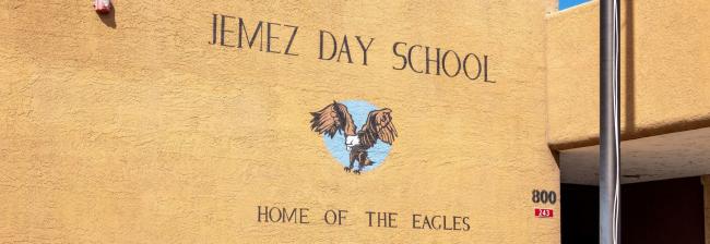 Jemez Day School Home of the Eagles written on outside of school building.